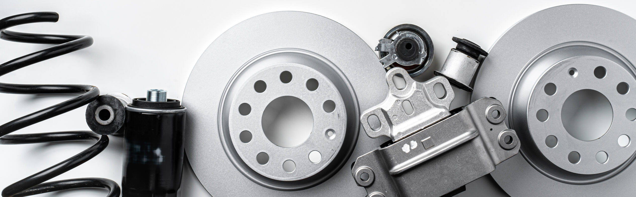 New metal auto parts on grey background